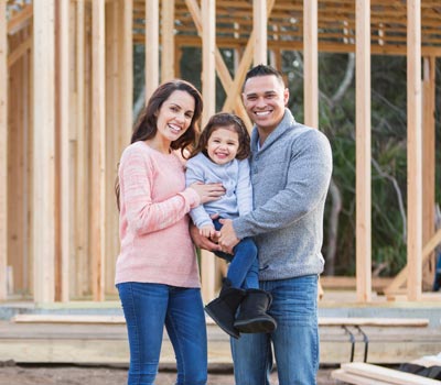 Family in front of wood frame